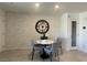 Cozy dining area featuring a modern table, four chairs, decorative wall art and a pantry at 3534 Alpheus River Ave, Las Vegas, NV 89106