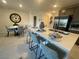 Stylish kitchen with a breakfast bar, stainless steel appliances, and view into dining area at 3534 Alpheus River Ave, Las Vegas, NV 89106