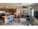 Open-concept living room and kitchen featuring modern decor, stainless steel appliances, and stylish furnishings at 3534 Alpheus River Ave, Las Vegas, NV 89106