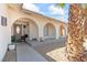 Charming home entrance with arched porch, desert landscaping, and neutral color palette at 3661 Margarita Way, Las Vegas, NV 89103
