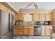 Bright and spacious kitchen featuring wood cabinets, stainless steel refrigerator and ample countertop space at 3661 Margarita Way, Las Vegas, NV 89103