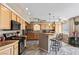 Well-lit kitchen with wood cabinets, pendant lighting over breakfast bar, and modern appliances at 3661 Margarita Way, Las Vegas, NV 89103