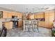 Spacious kitchen featuring wood cabinets, stainless steel appliances, and a convenient breakfast bar at 3661 Margarita Way, Las Vegas, NV 89103
