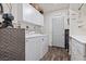 Well-equipped laundry room with modern washer and dryer, storage cabinets, and stylish flooring at 3661 Margarita Way, Las Vegas, NV 89103