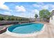 Backyard swimming pool surrounded by concrete and rock, framed by a block wall and landscaping at 3661 Margarita Way, Las Vegas, NV 89103