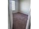 A bright bedroom with a window and neutral carpeting at 3750 S Rainbow Ave, Pahrump, NV 89048