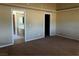 Bedroom featuring neutral walls and carpet, with an en-suite bathroom and a walk-in closet at 3750 S Rainbow Ave, Pahrump, NV 89048
