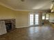 Living room featuring tiled floors, a cozy fireplace, and double doors leading to the outdoor space at 3750 S Rainbow Ave, Pahrump, NV 89048