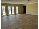 Large living room featuring tiled floors and access to the outdoors at 3750 S Rainbow Ave, Pahrump, NV 89048