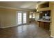 Open-concept living room with tile flooring, adjacent to the kitchen and leading to the backyard at 3750 S Rainbow Ave, Pahrump, NV 89048