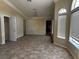 Bright living room featuring tiled floors and a large window, creating a comfortable space at 3750 S Rainbow Ave, Pahrump, NV 89048