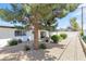 Beautiful backyard features a gravel area with mature trees and easy access to the home's entrance at 3805 San Angelo Ave, Las Vegas, NV 89102
