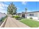 The backyard features a gravel area, artificial grass, and a seating area near the back door at 3805 San Angelo Ave, Las Vegas, NV 89102