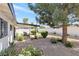 Spacious backyard featuring a covered patio, mature landscaping, and decorative gravel at 3805 San Angelo Ave, Las Vegas, NV 89102