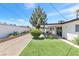Backyard showcasing gravel landscaping, artificial grass and a small covered patio area with outdoor furniture at 3805 San Angelo Ave, Las Vegas, NV 89102