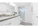 Beautiful bathroom with double sinks, gray countertops, and a tiled walk-in shower at 3805 San Angelo Ave, Las Vegas, NV 89102