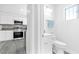 View into the bathroom and kitchen featuring white cabinets and stainless steel appliances at 3805 San Angelo Ave, Las Vegas, NV 89102