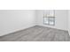 Bright bedroom with light gray wood-look flooring and a window with stylish bars at 3805 San Angelo Ave, Las Vegas, NV 89102