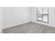 Bright bedroom with light gray wood-look flooring and a window with stylish bars at 3805 San Angelo Ave, Las Vegas, NV 89102