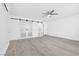 Bright bedroom with stylish barn doors, a modern ceiling fan, and sleek, contemporary design at 3805 San Angelo Ave, Las Vegas, NV 89102