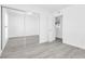 Bright bedroom with mirrored closet doors, doorway and gray floors at 3805 San Angelo Ave, Las Vegas, NV 89102