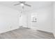 Bedroom featuring sleek sliding mirror closet doors, ceiling fan, and light gray wood-look flooring at 3805 San Angelo Ave, Las Vegas, NV 89102