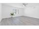 Bright bedroom with large window, ceiling fan, air conditioner, and gray floors at 3805 San Angelo Ave, Las Vegas, NV 89102