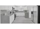 Modern kitchen with stainless steel appliances, gray quartz countertops, and a stylish backsplash at 3805 San Angelo Ave, Las Vegas, NV 89102