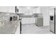 Well-lit kitchen with stainless steel appliances, stylish gray countertops, and sleek cabinetry at 3805 San Angelo Ave, Las Vegas, NV 89102