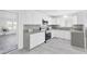 Updated kitchen with stainless steel appliances, gray countertops, and new white cabinets at 3805 San Angelo Ave, Las Vegas, NV 89102