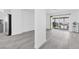 Bright and open living area with wood-look floors and large sliding doors to the backyard at 3805 San Angelo Ave, Las Vegas, NV 89102