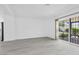 Spacious living area with wood-look floors and a large sliding glass door to the backyard at 3805 San Angelo Ave, Las Vegas, NV 89102