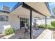 Relaxing covered patio with lounge chairs and beautifully landscaped gravel yard at 3805 San Angelo Ave, Las Vegas, NV 89102