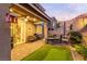 Inviting backyard featuring a patio, seating, putting green, and manicured landscaping at 39 Castleton Tower Ct, Henderson, NV 89011