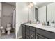 Bathroom featuring a toilet, shower/bathtub combination, and dual sink vanity with modern fixtures at 39 Castleton Tower Ct, Henderson, NV 89011