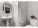 Powder room featuring a pedestal sink and decorative mirror at 39 Castleton Tower Ct, Henderson, NV 89011