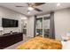 A primary bedroom features a television, ceiling fan, and sliding doors to the patio at 39 Castleton Tower Ct, Henderson, NV 89011