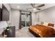 Bright bedroom featuring a ceiling fan, a sliding door to a patio and a television on the wall at 39 Castleton Tower Ct, Henderson, NV 89011