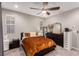 Comfortable bedroom featuring carpet, a ceiling fan, windows, and stylish decor at 39 Castleton Tower Ct, Henderson, NV 89011