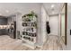Inviting entryway with decorative bookshelf, light wood floors, leading to the kitchen with stainless steel appliances at 39 Castleton Tower Ct, Henderson, NV 89011