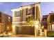 Beautiful two-story home featuring a two-car garage with brick paved driveway, shutters, and manicured landscaping at 39 Castleton Tower Ct, Henderson, NV 89011