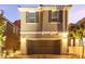 Charming two-story home featuring a two-car garage and a brick paved driveway providing excellent curb appeal at 39 Castleton Tower Ct, Henderson, NV 89011