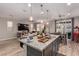 Open concept kitchen featuring a center island with granite countertop and dining area at 39 Castleton Tower Ct, Henderson, NV 89011