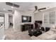Open concept living room with comfortable seating, ceiling fan, and carpeted floors at 39 Castleton Tower Ct, Henderson, NV 89011