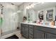 Main bathroom features a double vanity, walk-in shower, and neutral tones at 39 Castleton Tower Ct, Henderson, NV 89011
