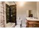 Bathroom featuring dark tiled shower, vanity with sink, and standard toilet at 3912 Palos Verdes St, Las Vegas, NV 89119