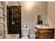 Bathroom featuring dark tiled shower, vanity with sink, and standard toilet at 3912 Palos Verdes St, Las Vegas, NV 89119
