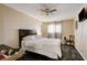 Bedroom features a dark wood bed frame and a ceiling fan at 3912 Palos Verdes St, Las Vegas, NV 89119
