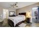 This bedroom features dark wood furniture, a ceiling fan, and a nearby washer and dryer at 3912 Palos Verdes St, Las Vegas, NV 89119