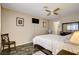 Bedroom features a ceiling fan, a wall-mounted television, and unique flooring at 3912 Palos Verdes St, Las Vegas, NV 89119